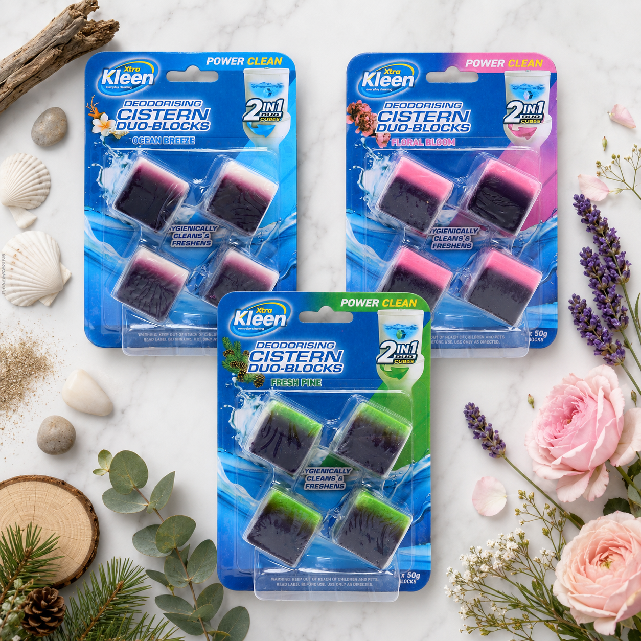 Multiple Xtra Kleen Cistern Duo-Cubes packs arranged with fresh pink flowers on a marble surface